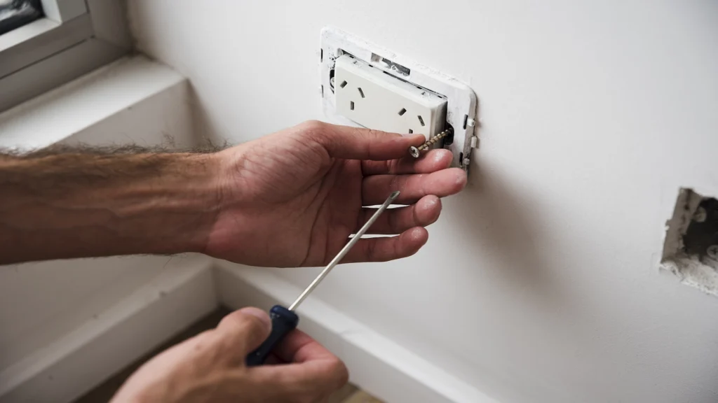 close up hand fixing electric power points socket